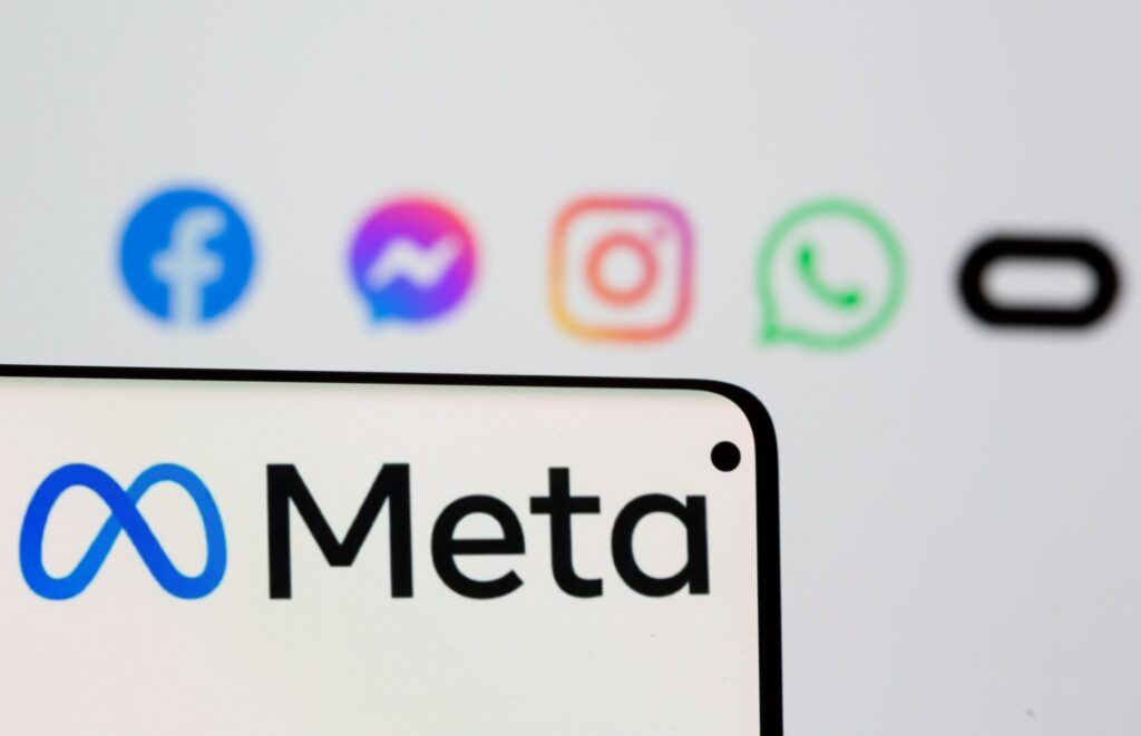 Facebook's new rebrand logo Meta is seen on smartphone in front of displayed logo of Facebook, Messenger, Instagram, Whatsapp and Oculus in this illustration picture taken October 28, 2021. REUTERS/Dado Ruvic/Illustration