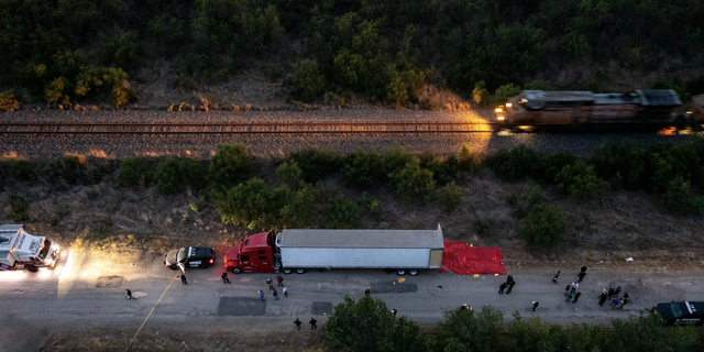 In this aerial view, members of law enforcement investigate a tractor trailer on June 27, 2022 in San Antonio, Texas. 