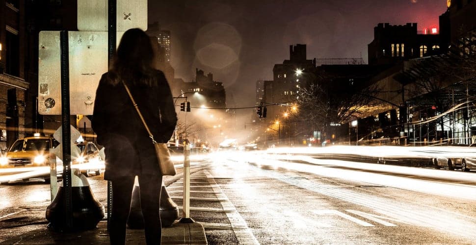 Young woman standing on road at night in Ukraine