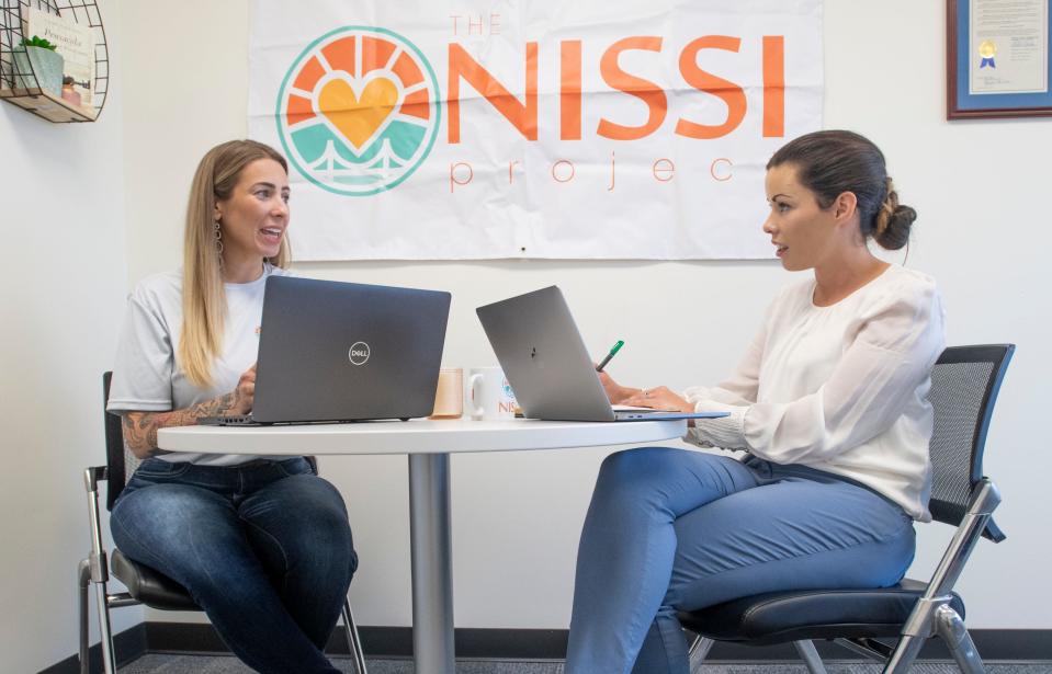 Sara Lefevers, NISSI president and CEO, right, and Kelsey Hill, communications director and founder of Beyond Beauty, discuss plans for a NISSI Project fundraiser in Pensacola on Tuesday, May 4, 2021.