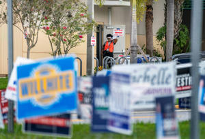Aug 23, 2022; Wellington, FL, USA; An election deputy waits for more voters during primary day elections at a polling station at the Wellington Branch Library on August 23, 2022 in Wellington, Florida. Mandatory Credit: Greg Lovett-USA TODAY NETWORK ORIG FILE ID: 20220823_ajw_usa_025.JPG
