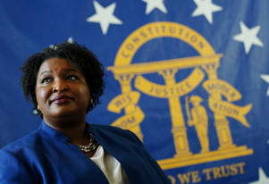 HOLD FOR STORY BY JEFF AMY EMBARGOED UNTIL 06:00 AM EST Aug. 9, 2020**Democratic candidate for Georgia Governor Stacey Abrams poses for a portrait in front of the State Seal of Georgia Monday, Aug. 8, 2022, in Decatur, Ga. (AP Photo/John Bazemore) ORG XMIT: WX213
