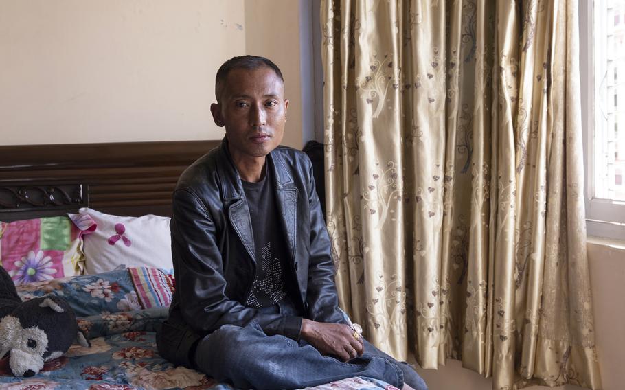 Anil Lama, a former I.T. migrant worker for KGL at an American military installation in Kuwait, poses for a portrait at his residence in Kathmandu, Nepal on Oct. 8, 2022.