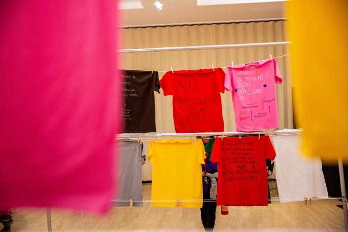 ‘I found my voice’: NMSU students share stories of abuse through interactive T-shirt exhibit