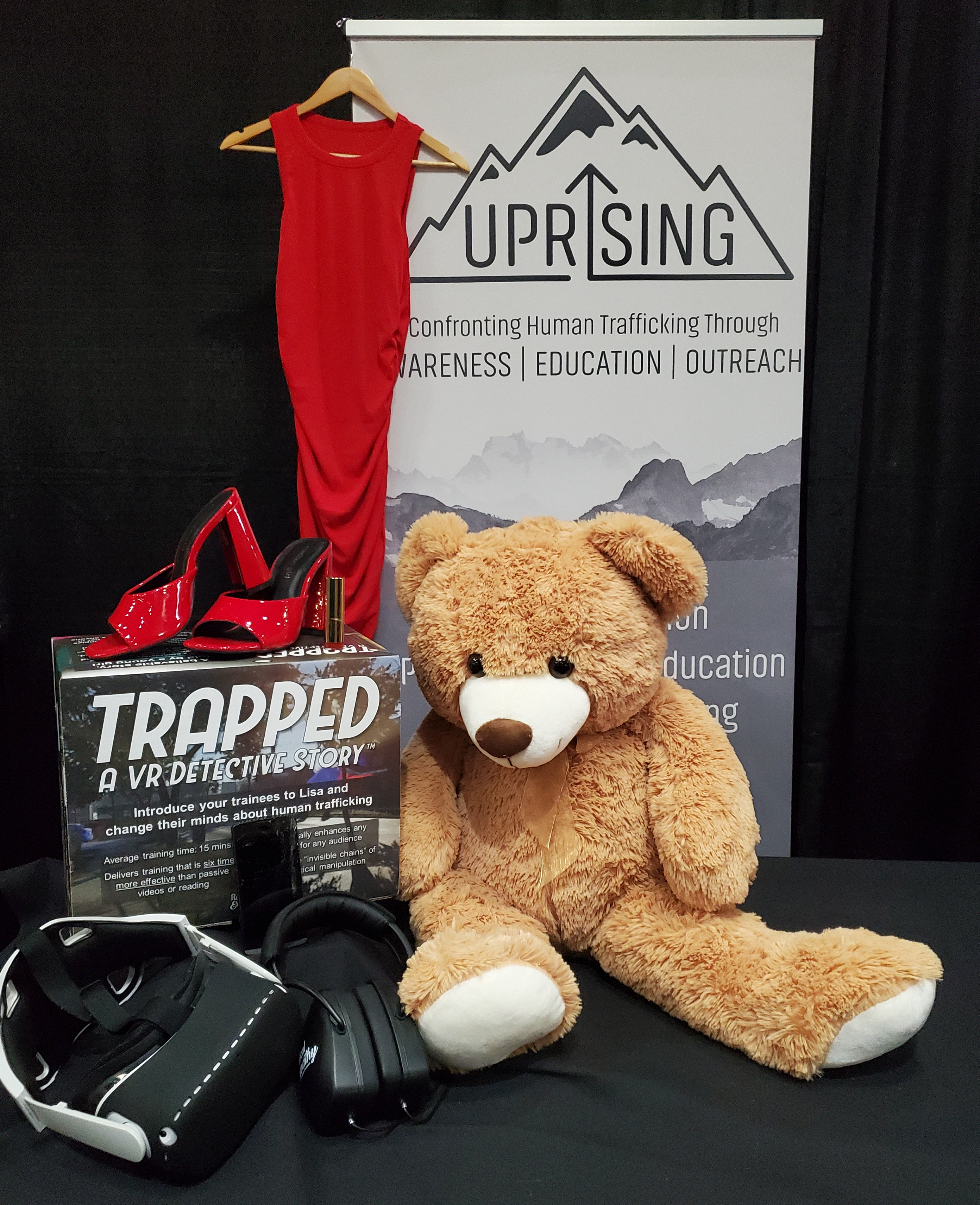 Uprising purchased physical models of the virtual objects from TRAPPED. Pictured here are Lisa's teddy bear, dress, shoes, lipstick, and her cell phone. All of these are important parts of Lisa's life, and seeing them can make a dramatic impact for trainees.