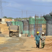 Chinese construction workers work on a Chinese-financed railway in Taru, Kenya, in March 2016. Beijing's foreign loans exceed 6% of global gross domestic product, making it competitive with the IMF as a global creditor. | BLOOMBERG
