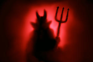 Creepy Devil silhouette from hell in the mist with backlit. (Getty Images)