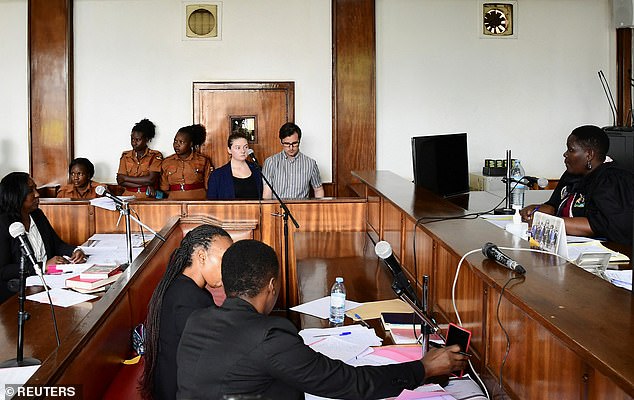 Nicholas Spencer and his wife, Mackenzie Leigh Mathias Spencer, both 32, stand in the dock at Buganda Road Court, where they were charged with torturing a 10-year old