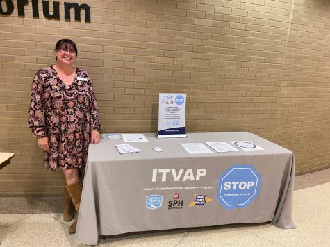 Amy Wilkerson, adult learner support specialist, promotes the resource table brought by the Indiana Trafficking Victims Assistance Program. The table shared resources to help people spot red flags and make reports for sex trafficking. The table was featured at the "Shattered Dreams" film screening and panel discussion event Tuesday at the Mitchell Auditorium in the Health Professions Center. (Photo by Alyson Collins)