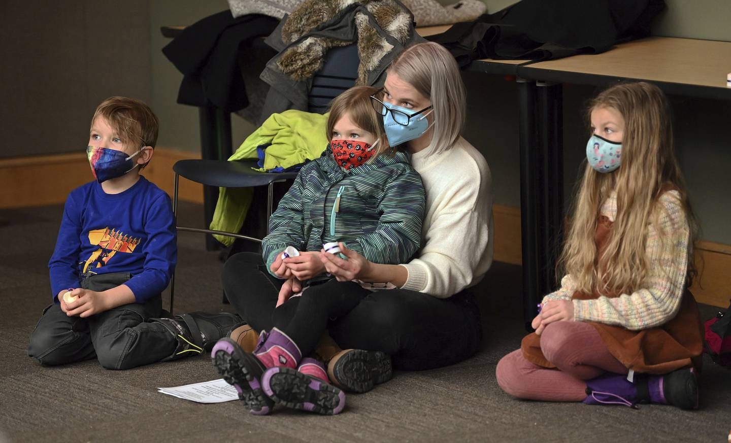 Seated in the audience are Christine Lensing of Waukegan and her children, from right to left, Jazmine, 8, a third grader, Audrey, 7, a first grader, and Desmond, 5, a preschooler, at the Human Trafficking Awareness Candle Vigil on Jan. 30, 2023 at the Waukegan Public Library in the Ray Bradbury Room.