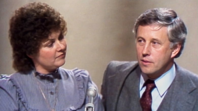 As seen in a scene from Satan Wants You, Michelle Smith and Dr. Lawrence Pazder appear on To Tell the Truth in 1980. They are a white woman and white man who appear in medium closeup. Dr. Pazder appears to be talking, Michelle turns her head toward him, listening.