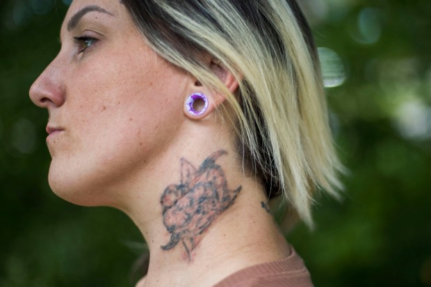 A tattoo is seen on Olivia Reposa's neck at Mount Trashmore in Virginia Beach on Friday, September 1, 2023. The tattoo was originally a brand from one of Reposa's traffickers that she had covered. Now she is currently in the process of having it removed. (Kendall Warner/The Virginian-Pilot)