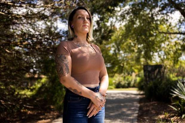 Human trafficking survivor Olivia Reposa, 32, poses for a portrait at Mount Trashmore in Virginia Beach on Friday, September 1, 2023. (Kendall Warner/The Virginian-Pilot)