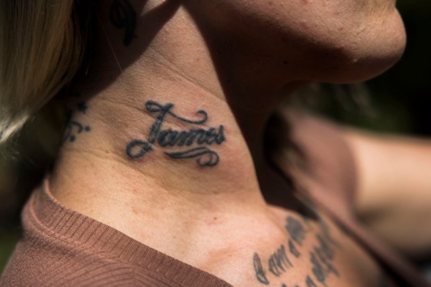 A brand featuring the name of one of Olivia Reposa's traffickers remains tattooed on her neck. Photographed at Mount Trashmore in Virginia Beach on Friday, September 1, 2023. (Kendall Warner/The Virginian-Pilot)